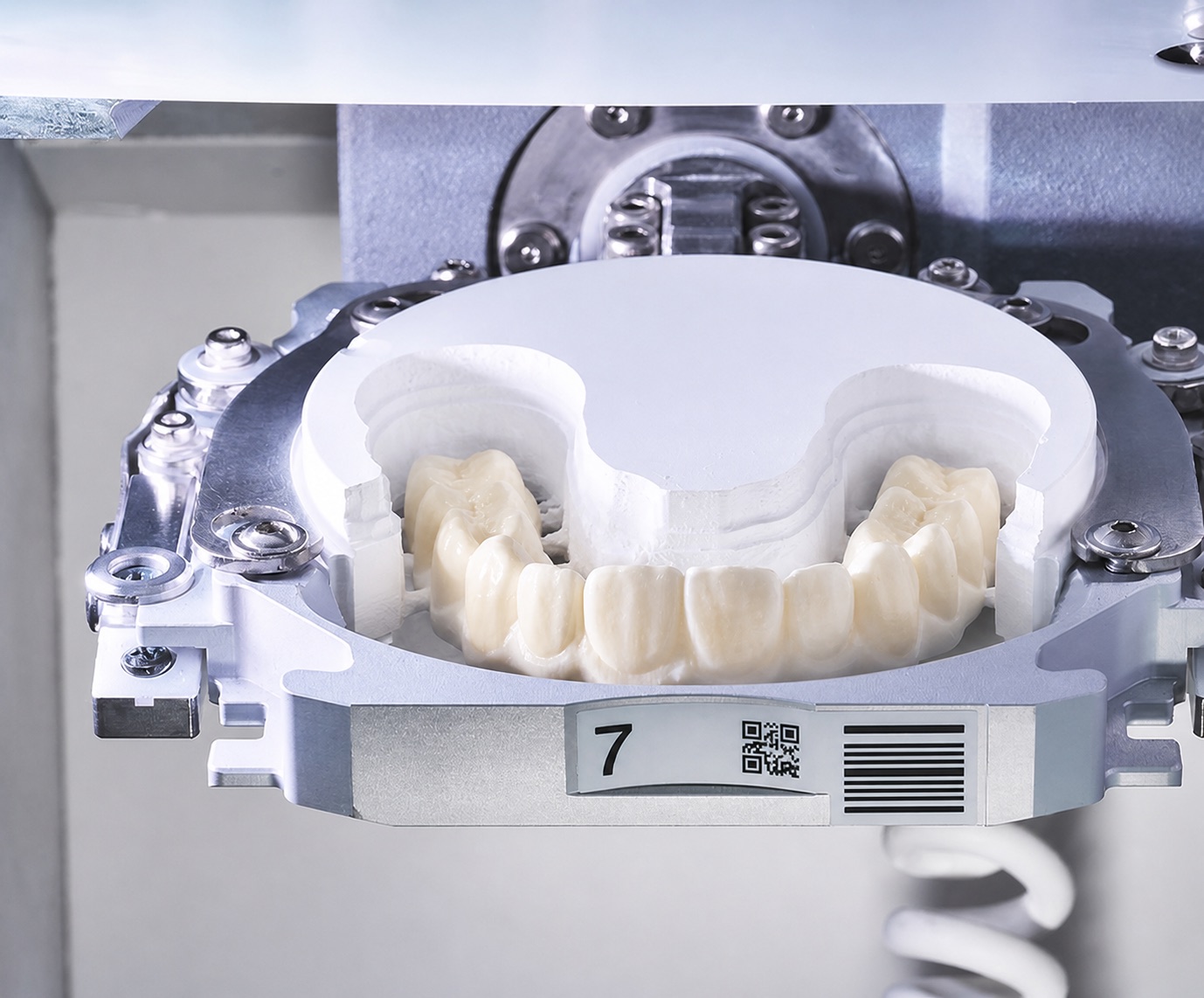 Natural tooth-colored zirconia restorations being created inside an in-house dental mill